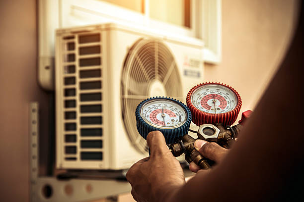 Professional Air Conditioning Service technician working in Louisa, KY